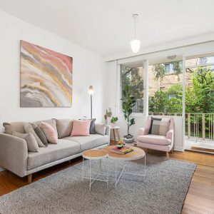 A living room with grey sofa and pink accents - Melbourne Interior Design - Leeder Interiors