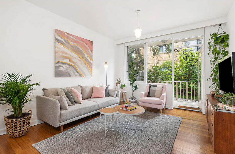 A living room with grey sofa and pink accents - Melbourne Interior Design - Leeder Interiors