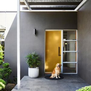 A mustard coloured front door on a grey home - Melbourne Interior Design - Leeder Interiors