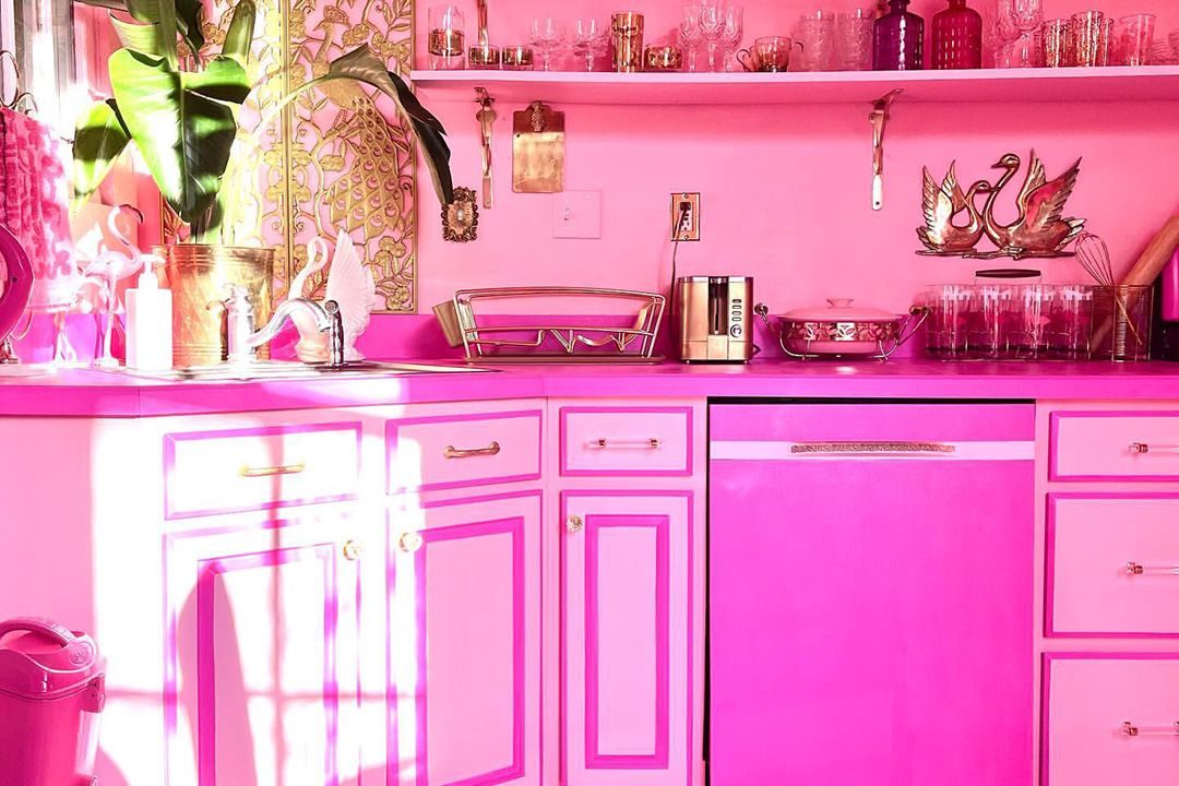A kitchen decorated in bright pink, inspiration for a barbiecore interior.