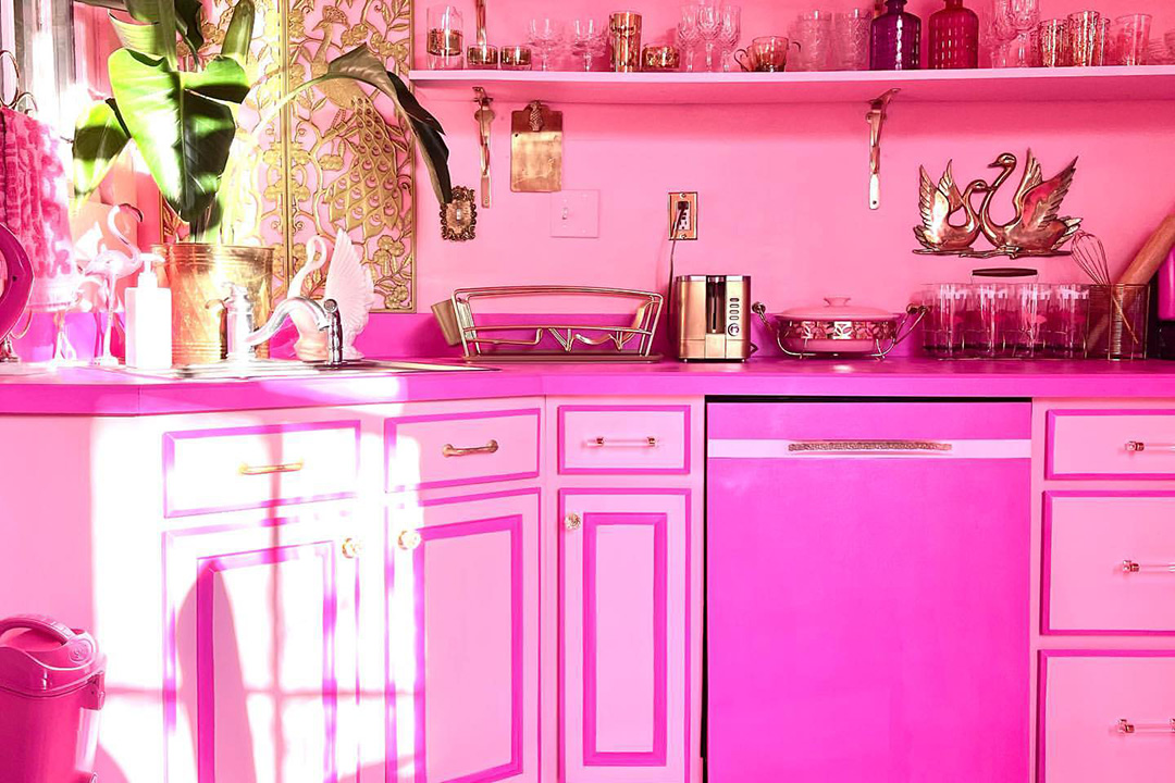 A kitchen decorated in bright pink, inspiration for a barbiecore interior.