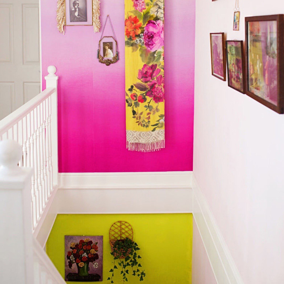 A stairway painted in pink and yellow, inspiration for a barbiecore interior.